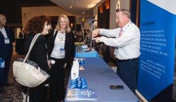 People Chatting at an Event Booth