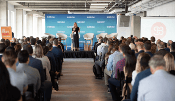 Event Speaker In Front Of Crowd